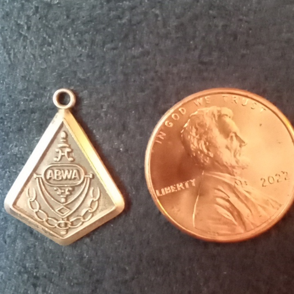 3/4" sterling silver ABWA charm stamped with "r" and "sterling"